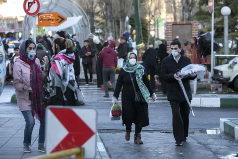 Người dân đeo khẩu trang để phòng tránh lây nhiễm COVID-19 tại Tehran, Iran, ngày 19/3/2020. (Ảnh: THX/TTXVN)