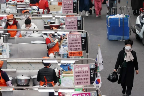 Người dân mua hàng hóa tại một khu chợ ở Daegu, Hàn Quốc ngày 25/3/2020, trong bối cảnh dịch COVID-19 lan rộng. (Ảnh: THX/TTXVN)