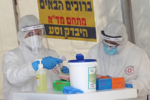 Nhân viên y tế Israel làm việc tại một trạm xét nghiệm COVID-19 ở Jerusalem, ngày 2/4/2020. (Ảnh: THX/TTXVN)