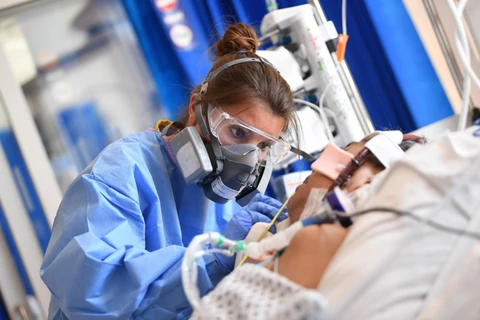 Nhân viên y tế điều trị cho bệnh nhân nhiễm COVID-19 tại bệnh viện Hoàng gia Papworth ở Cambridge, Anh ngày 5/5/2020. (Ảnh: AFP/TTXVN)