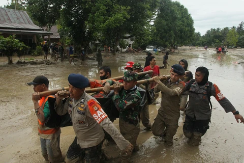 Nhân viên cứu hộ chuyển thi thể nạn nhân thiệt mạng trong trận lũ quét ở Radda, Nam Sulawesi, Indonesia, ngày 14/7/2020. (Ảnh: AFP/TTXVN)