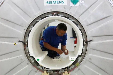 Một nhân viên làm việc trên một máy chụp ảnh cộng hưởng từ tại một dây chuyền sản xuất của Siemens Healthineers ở Thâm Quyến, Trung Quốc ngày 25/5/2018. (Nguồn: Reuters)