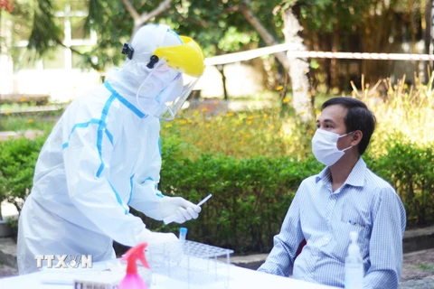 Thành viên Ban in sao đề thi lấy mẫu xét nghiệm virus SARS-CoV-2 nhằm đảm bảo an toàn cho kỳ thi. (Ảnh: Văn Dũng/TTXVN)