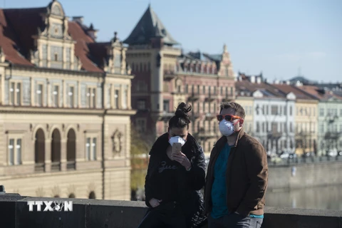 Người dân đeo khẩu trang phòng COVID-19 tại Prague, CH Séc ngày 18/3/2020. (Ảnh: AFP/TTXVN)
