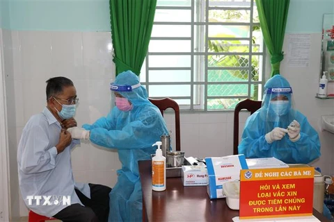 Nhóm nguy cơ cao là người lớn tuổi được ưu tiên tiêm mũi 3 vaccine phòng COVID-19 tại Tiền Giang. (Ảnh: Hữu Chí/TTXVN)