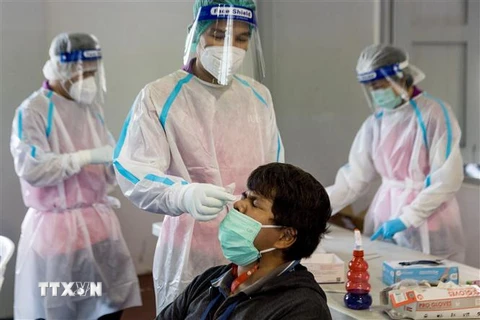 Nhân viên y tế lấy mẫu xét nghiệm COVID-19 tại Bangkok, Thái Lan ngày 24/2/2022. (Ảnh: AFP/TTXVN)
