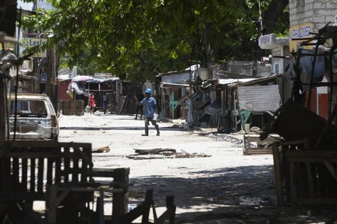 Một người đàn ông băng qua đường có rào chắn trong cuộc đụng độ giữa các băng nhóm có vũ trang ở khu phố La Plaine của Port-au-Prince, Haiti ngày 6 tháng 5 năm 2022. (Nguồn: AP)