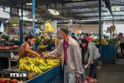 Người dân mua sắm tại chợ ở Caracas, Venezuela. (Ảnh: AFP/TTXVN)