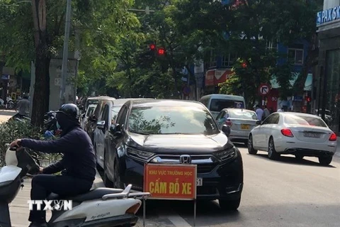 Mặc dù có biển cấm, nhưng ôtô vẫn đỗ ngang nhiên trước cổng trường học trên phố Hòa Mã (Hà Nội). (Ảnh: Tuyết Mai/TTXVN)