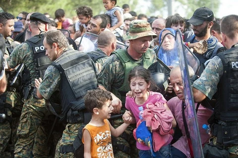 Những đứa trẻ gào khóc trong tuyệt vọng khi cảnh sát chống bạo động Macedonia trấn áp 3.000 người di cư. (Ảnh: AFP)