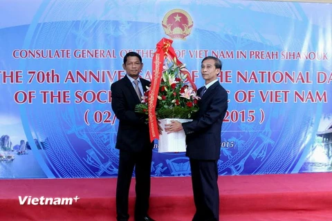 Tổng Lãnh sự Việt Nam tại Sihanoukville Đỗ Sỹ Kiều (phải) nhận hoa chúc mừng của đại diện tỉnh Kampot, Campuchia (trái), nhân kỷ niệm 70 năm Quốc khánh. (Ảnh: Xuân Khu/Vietnam+)