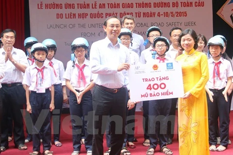 Trao tặng mũ bảo hiểm cho học sinh trường Trung học cơ sở Tân Định. Ảnh minh họa. (Ảnh: Việt Hùng/Vietnam+)