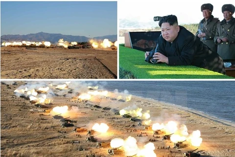 Nhà lãnh đạo Triều Tiên Kim Jong-ul (ảnh trên, góc phải) đã thị sát và chỉ đạo một cuộc tập trận pháo binh. (Nguồn: Yonhap/TTXVN)