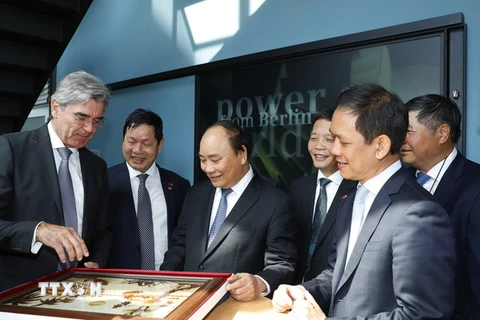 Thủ tướng Nguyễn Xuân Phúc đến tham quan nhà máy sản xuất turbine khí của Hãng Siemens. (Ảnh: Thống Nhất/TTXVN)
