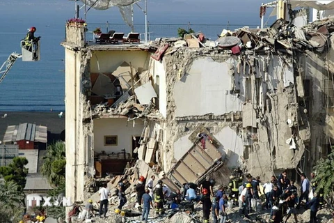 Lực lượng cứu hộ tìm kiếm những người bị mất tích trong đống đổ nát của tòa chung cư bị sập ở Torre Annunziata, Italy ngày 7/7. (Nguồn: EPA/TTXVN)