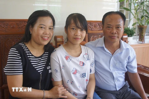Em Hà Phương và bố mẹ trong niềm vui đón nhận danh hiệu thủ khoa toàn quốc. (Nguồn: TTXVN)