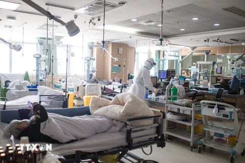 Nhân viên y tế điều trị cho bệnh nhân nhiễm dịch viêm đường hô hấp cấp COVID-19 tại bệnh viện Vũ Hán, tỉnh Hồ Bắc, Trung Quốc ngày 22/2/2020. (Ảnh: THX/TTXVN)