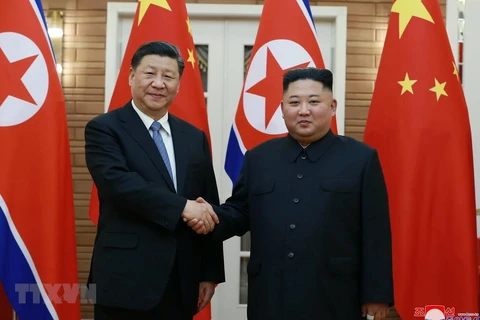Nhà lãnh đạo Triều Tiên Kim Jong-un (phải) và Chủ tịch Trung Quốc Tập Cận Bình hôm 20/6. (Nguồn: Yonhap/TTXVN)