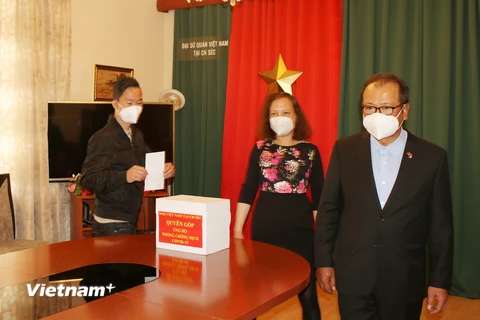 Cán bộ, nhân viên Đại sứ quán Việt Nam tại Séc quyên góp hỗ trợ phòng chống dịch trong nước. (Ảnh: Hồng Kỳ/Vietnam+)