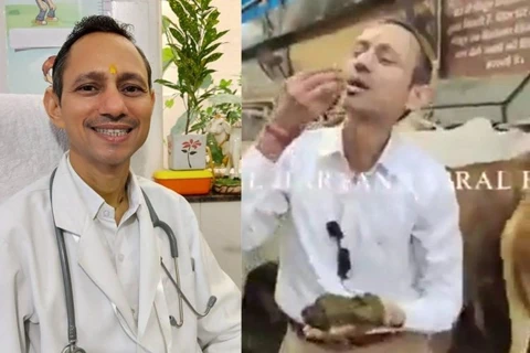 Hình ảnh bác sỹ người Ấn Độ Mittal đang cắn một miếng phân bò. (Nguồn: odditycentral.com)