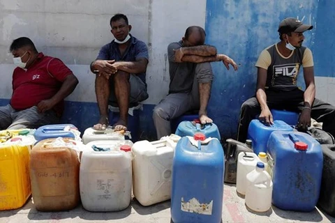 Người dân Sri Lanka ngồi chờ để mua dầu. (Nguồn: Reuters)