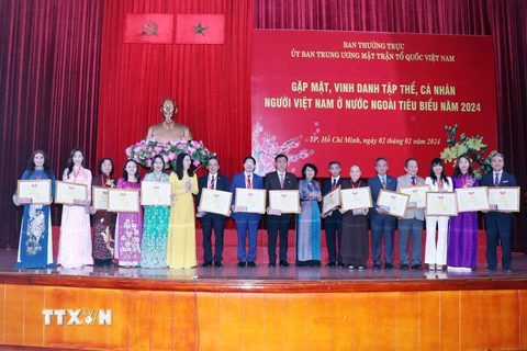 Trao tặng Bằng khen của Ủy ban Trung ương Mặt trận Tổ quốc Việt Nam cho các cá nhân kiều bào tiêu biểu. (Ảnh: Xuân Khu/TTXVN)