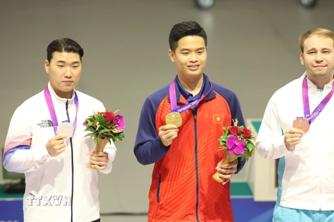 Xạ thủ Phạm Quang Huy (giữa) giành Huy chương Vàng đầu tiên cho thể thao Việt Nam ở ASIAD 2023. (Ảnh: TTXVN phát)