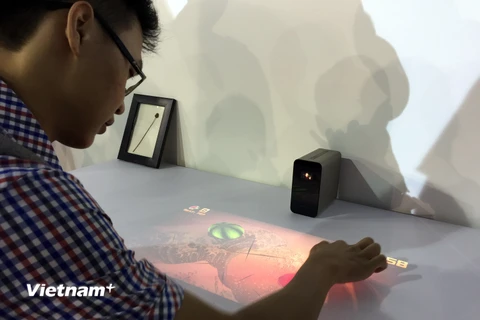 Trải nghiệm chơi trò chơi trên mặt gỗ nhờ thiết bị Xperia Touch-sản phẩm có thể "biến" mặt phẳng thành màn hình cảm ứng của Sony. (Ảnh: Trung Hiền/Vietnam+) 