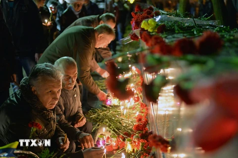 Người dân Ukraine thắp nến và đặt hoa tại tượng đài các nạn nhân của thảm họa Chernobyl tại Slavutich. (Nguồn: AFP/TTXVN)