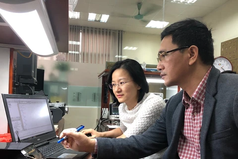 Tiến sỹ Kiều Hà trao đổi công việc với đồng nghiệp.