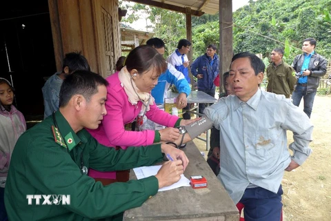 Bác sỹ quân y đồn biên phòng Đắc Pring khám chữa bệnh cho người dân tại cụm bản Pêtapoóc, Quảng Nam. (Ảnh: TTXVN/Vietnam+)