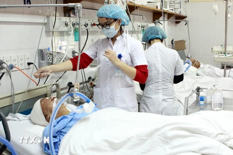 Nhân viên y tế chăm sóc cho bệnh nhân sau phẫu thuật. (Ảnh: TTXVN/Vietnam+)