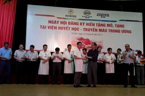 Trao thẻ hiến tạng cho cán bộ của Viện huyết học và Truyền máu Trung ương. (Ảnh: PV/Vietnam+)
