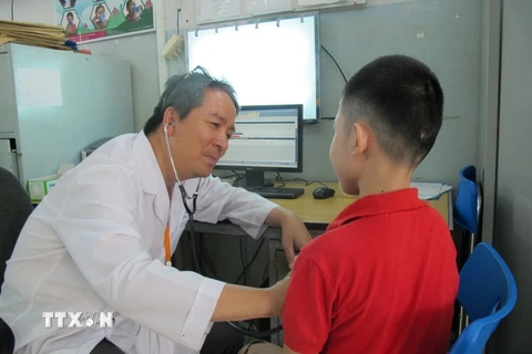 Bác sỹ Bệnh viện Phạm Ngọc Thạch kiểm tra bệnh về phổi cho trẻ em mắc bệnh lao. (Ảnh: TTXVN/Vietnam+))