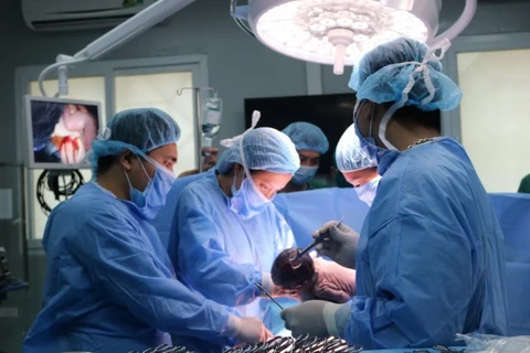 Các bác sỹ tiến hành ca phẫu thuật. (Ảnh: PV/Vietnam+)