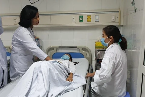 Bác sỹ Hoa khám cho bệnh nhân trước khi mổ. (Ảnh: PV/Vietnam+)