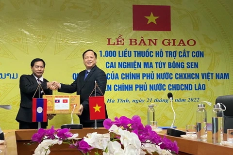 Đại diện Chính phủ Việt Nam trao tặng thuốc cho đại diện Chính phủ Lào. (Ảnh: PV/Vietnam+)