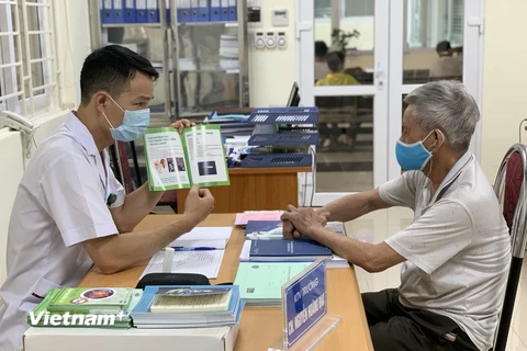 Bác sĩ Bệnh viện Phổi Trung ương tư vấn cho người dân về bệnh lao. (Ảnh: PV/Vietnam+)