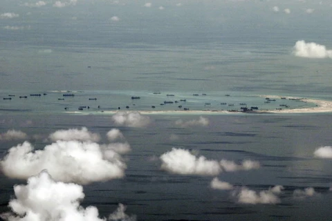 Tàu Trung Quốc cải tạo đất trên một rạn san hô ở Biển Đông. (Nguồn: Reuters)