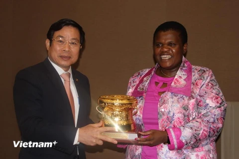 Bộ trưởng Nguyễn Bắc Son trao tặng phẩm cho Bộ trưởng Truyền thông Nam Phi Faith Muthambi. (Ảnh: Mạnh Hùng/Vietnam+)