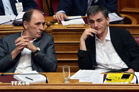 Bộ trưởng Kinh tế và Bộ trưởng Tài chính Hy Lạp thảo luận trước phiên họp Quốc hội ở Athens. (Nguồn: AFP/TTXVN)