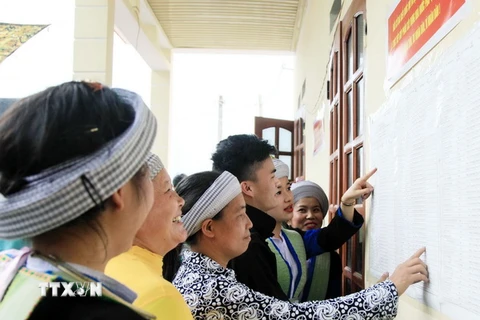 Đồng bào dân tộc Mông xã Quang Sơn, huyện Đồng Hỷ xem danh sách cử tri niêm yết tại Nhà văn hóa. (Ảnh: Thu Hằng/TTXVN)