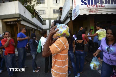 Người dân Venezuela chờ mua hàng hóa tại một siêu thị ở Caracas. (Nguồn: AFP/TTXVN)
