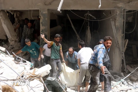 Lực lượng dân phòng Syria làm nhiệm vụ tại khu vực đổ nát sau một vụ tấn công ở Sukkari, vùng lân cận phía Bắc thành phố Allepo. (Nguồn: AFP/TTXV) 