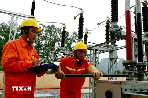 Công nhân của EVN Hà Nội kiểm tra vận hành điện. (Ảnh: Huy Hùng/TTXVN)