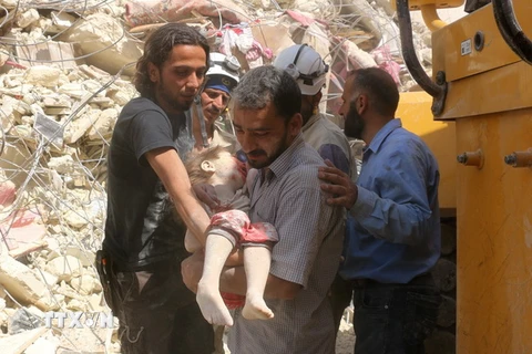 Chuyển thi thể một em nhỏ thiệt mạng trong cuộc giao tranh ở khu vực Tariq al-Bab, Aleppo. (Nguồn: AFP/TTXVN)