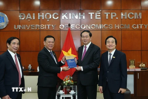 Chủ tịch nước Trần Đại Quang tặng sách cho Ban lãnh đạo nhà trường. (Ảnh: Nhan Sáng/TTXVN)