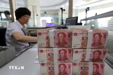 Kiểm đồng nhân dân tệ tại một ngân hàng ở Liên Vận Cảng, tỉnh Giang Tô, Trung Quốc. (Nguồn: AFP/TTXVN)