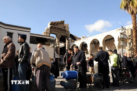 Người dân Syria xếp hàng chờ mua gas tại Damascus. (Nguồn: EPA/TTXVN)