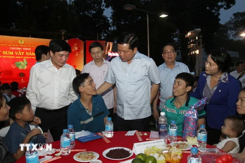 Bí thư Thành ủy Thành phố Hồ Chí Minh Đinh La Thăng thăm hỏi công nhân. (Ảnh: Phương Vy/TTXVN)